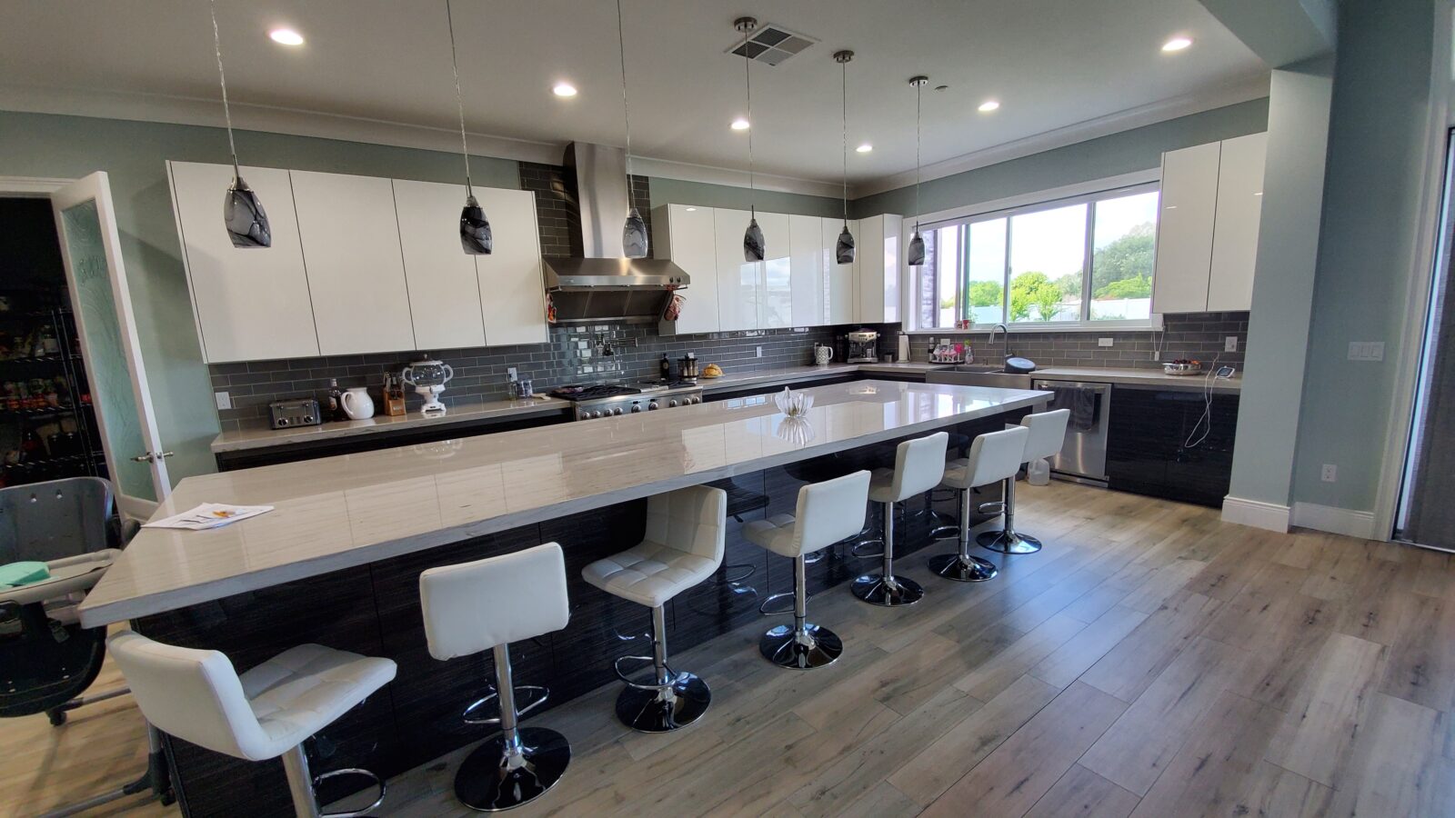 Long island kitchen. Oversized kitchen island. High gloss modern high countertop.