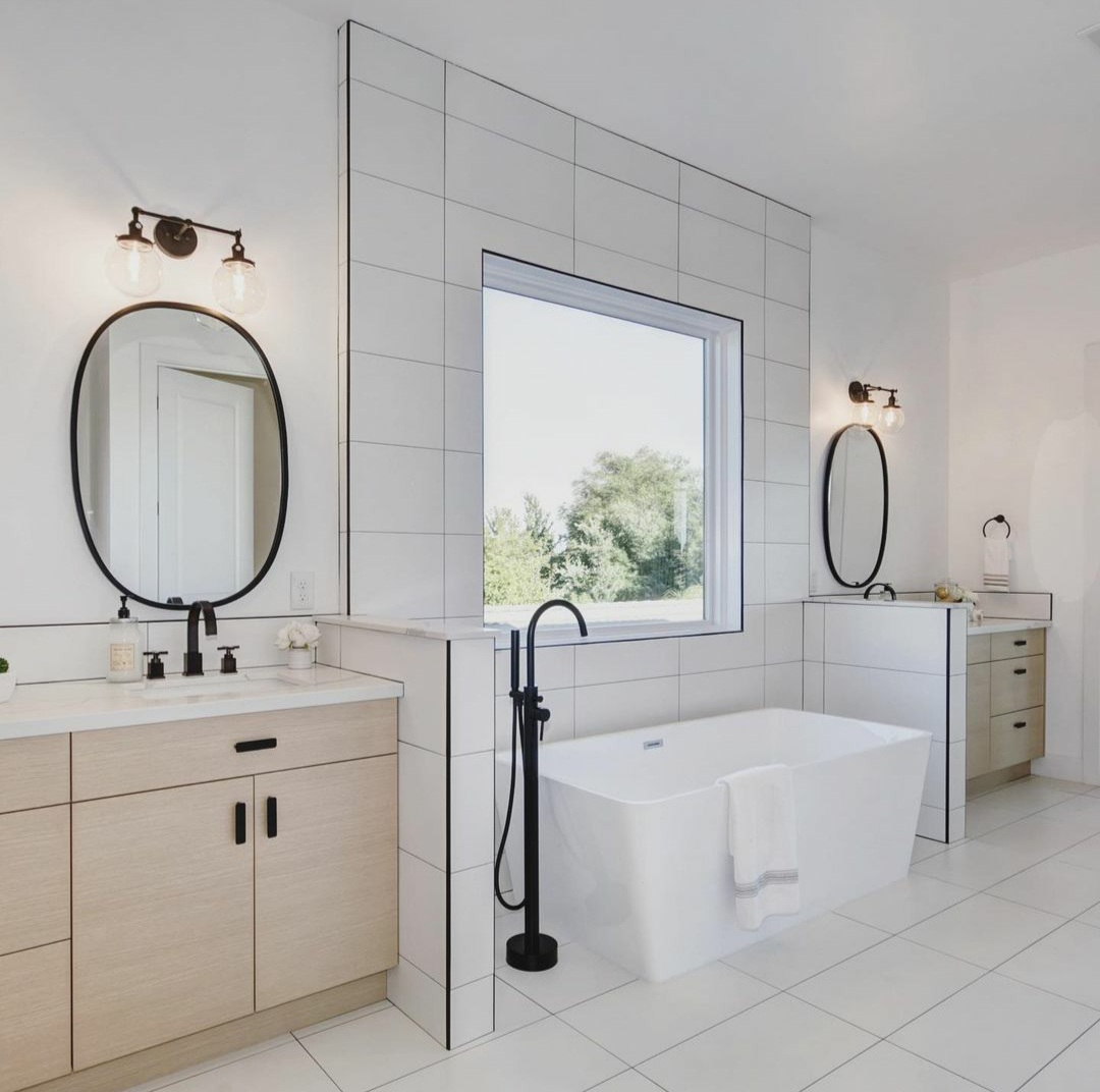 Modern bathroom cabinets. Flat door vanity. Stand alone bath tub. Flat doors cabinets and tile.