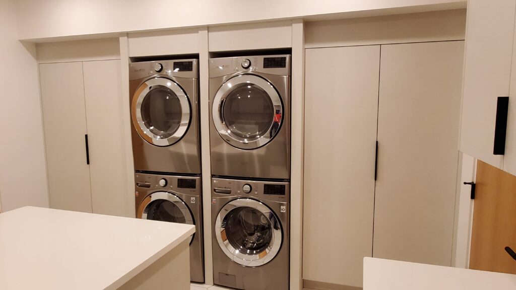Built-in modern laundry room cabinets. Linen closets. Custom modern laundry room.