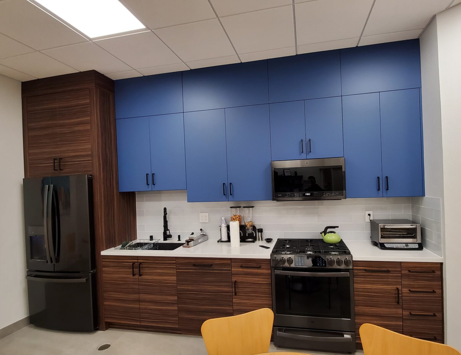 Modern break room. Commercial kitchen. Office kitchen. Slab door kitchen. Flat door kitchen.