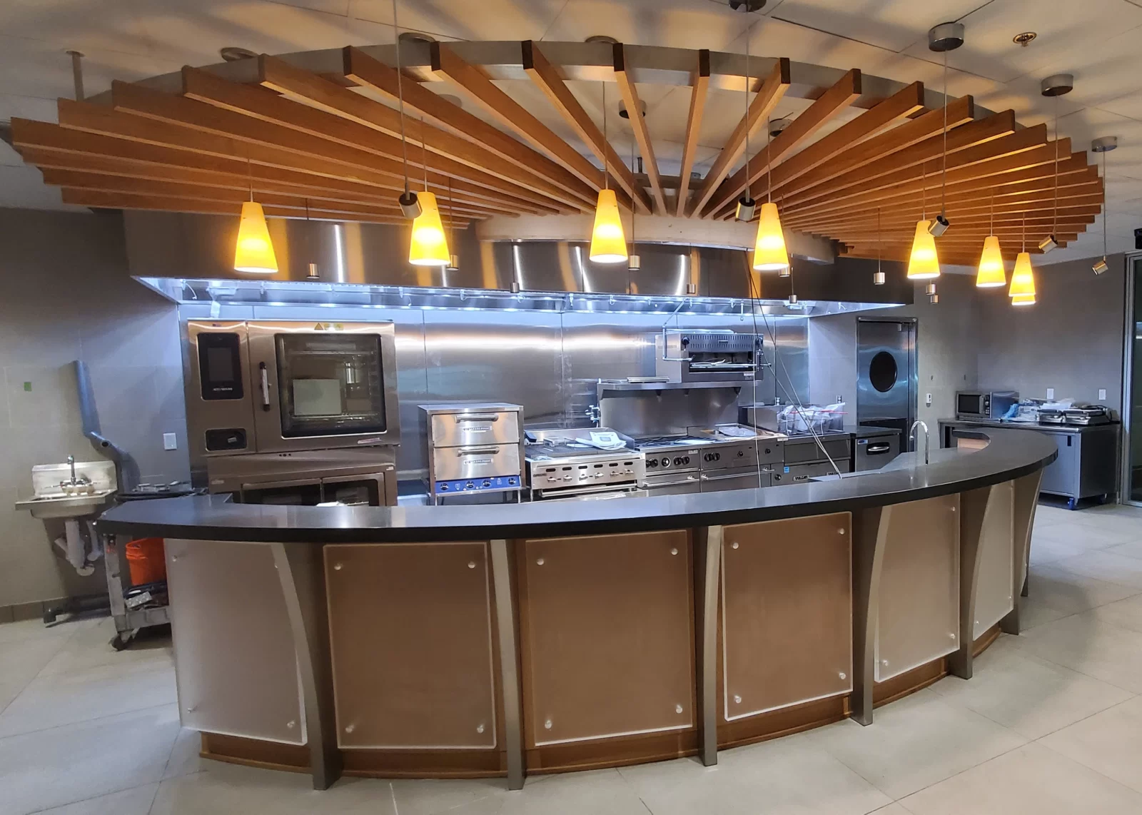 Custom commercial kitchen. Serving counter. Round counter stand. Solid wood ceiling trellis.