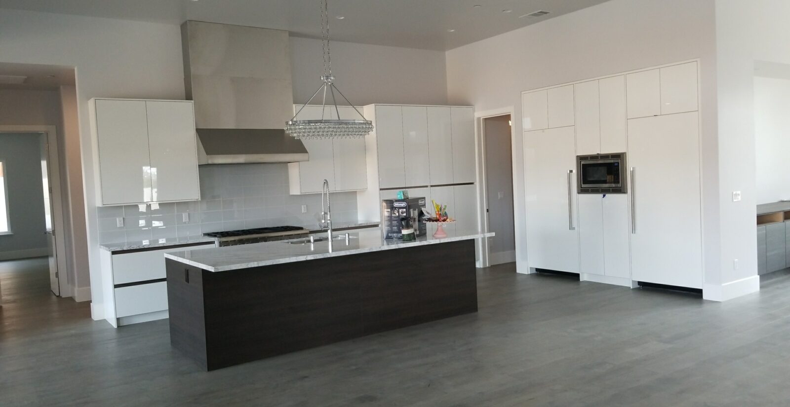 High gloss modern kitchen. Combination of wood and white granite